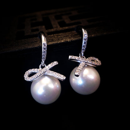Pendientes colgantes de perla con lazo precioso 